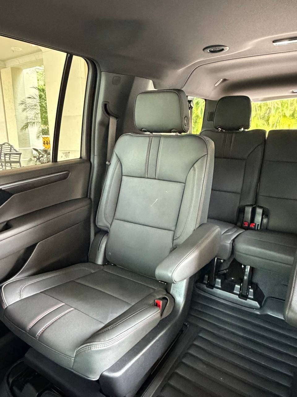 Black leather second-row captain's seats inside the Onyx Executive Miami Suburban